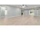 Open-concept living room with sleek flooring, recessed lighting, and access to outdoor spaces at 19028 Sw 101 Pl, Dunnellon, FL 34432
