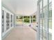 Screened-in patio with tile flooring and serene backyard views at 19028 Sw 101 Pl, Dunnellon, FL 34432
