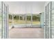 Enclosed and tiled screened-in porch offering views of the wooded backyard at 19028 Sw 101 Pl, Dunnellon, FL 34432