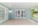 Cozy screened-in porch with tile flooring offering a peaceful outdoor retreat at 19028 Sw 101 Pl, Dunnellon, FL 34432