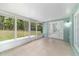 This tiled screened-in porch features backyard views, and access to the yard at 19028 Sw 101 Pl, Dunnellon, FL 34432
