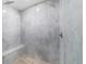 Modern shower featuring marble tile, wood-look flooring and bench seating at 19028 Sw 101 Pl, Dunnellon, FL 34432