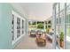 Relaxing screened-in patio with comfortable seating and lush backyard views at 19028 Sw 101 Pl, Dunnellon, FL 34432