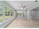 Bright sunroom boasting tile floors, large windows offering natural light, and a ceiling fan at 19028 Sw 101 Pl, Dunnellon, FL 34432