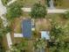 Aerial view of a home featuring a spacious backyard with greenery and a detached structure at 19370 Saint Benedict Dr, Dunnellon, FL 34432