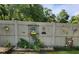Decorative backyard fence adorned with whimsical art and flourishing plants at 19370 Saint Benedict Dr, Dunnellon, FL 34432