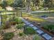 Lush backyard features a stepping stone walkway, landscaping and firepit at 19370 Saint Benedict Dr, Dunnellon, FL 34432
