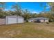 Large yard with outdoor patio area and shed, perfect for enjoying outdoor living and storage at 19370 Saint Benedict Dr, Dunnellon, FL 34432