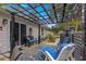 Cozy backyard patio features comfortable lounge seating, pergola, and serene outdoor space at 19370 Saint Benedict Dr, Dunnellon, FL 34432