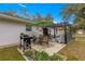 This patio area offers space for outdoor grilling, dining, and relaxing with an umbrella covered table at 19370 Saint Benedict Dr, Dunnellon, FL 34432