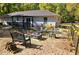 Outdoor setting for gathering with fire pit, seating and beautiful garden landscape for entertaining at 19370 Saint Benedict Dr, Dunnellon, FL 34432