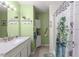 Bright bathroom featuring a shower/tub combo with a decorative botanical shower curtain at 19370 Saint Benedict Dr, Dunnellon, FL 34432