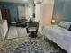 Intimate bedroom featuring a round table, chairs, a comfortable bed, and a vibrant floral rug at 19370 Saint Benedict Dr, Dunnellon, FL 34432