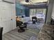 Cozy garage converted into a living space with chairs, bed, floral rug, and natural light at 19370 Saint Benedict Dr, Dunnellon, FL 34432
