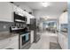 Bright kitchen with stainless steel appliances, granite countertops, and white cabinets at 19370 Saint Benedict Dr, Dunnellon, FL 34432