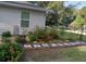 Professionally landscaped yard with stepping stones, lush plants, and decorative elements at 19370 Saint Benedict Dr, Dunnellon, FL 34432