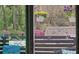 Inviting porch view showcasing colorful hanging flower baskets and decorative sea-themed accents at 19370 Saint Benedict Dr, Dunnellon, FL 34432