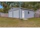 Large metal shed with dual roll up doors and separate entry door at 19370 Saint Benedict Dr, Dunnellon, FL 34432
