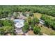 Aerial view of community amenities with a golf course, tennis courts, pool, and clubhouse at 19942 Sw 96Th Pl, Dunnellon, FL 34432