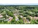 Aerial view of a neighborhood with lush trees, well-kept lawns, and various single-Gathering homes at 19942 Sw 96Th Pl, Dunnellon, FL 34432