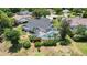 Aerial view of a spacious backyard featuring a screened-in pool, lush landscaping, and an outdoor fire pit at 19942 Sw 96Th Pl, Dunnellon, FL 34432