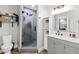 Updated bathroom with a walk-in shower featuring modern fixtures and gray cabinetry at 19942 Sw 96Th Pl, Dunnellon, FL 34432