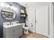 Stylish bathroom with a round mirror, subway tile backsplash, and updated fixtures at 19942 Sw 96Th Pl, Dunnellon, FL 34432