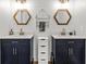 Bathroom with double sink, hexagonal mirrors and modern vanity providing both style and functionality at 19942 Sw 96Th Pl, Dunnellon, FL 34432