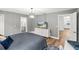 Bright bedroom with hardwood floors, a modern dresser, and a view of the ensuite bathroom at 19942 Sw 96Th Pl, Dunnellon, FL 34432