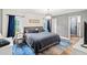 Comfortable primary bedroom with dark blue accents, stylish decor, and a relaxing atmosphere at 19942 Sw 96Th Pl, Dunnellon, FL 34432
