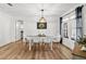 Bright dining room features wood-look flooring, modern lighting, and a dining table that seats six at 19942 Sw 96Th Pl, Dunnellon, FL 34432