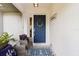 Cozy front porch with seating, a decorative wreath on the door, and a welcoming rug at 19942 Sw 96Th Pl, Dunnellon, FL 34432