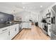 Modern kitchen with white cabinetry, stainless steel appliances, and an eat-in island at 19942 Sw 96Th Pl, Dunnellon, FL 34432