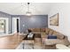 Cozy living room with sectional sofa, modern lighting, and stylish decor, perfect for relaxation and entertaining at 19942 Sw 96Th Pl, Dunnellon, FL 34432