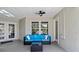 Comfortable patio with a blue sofa, coffee table, and view of the backyard at 19942 Sw 96Th Pl, Dunnellon, FL 34432