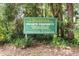 Green sign indicating private property for members and guests of Rainbow Springs community at 19942 Sw 96Th Pl, Dunnellon, FL 34432
