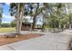 Outdoor recreation area featuring picnic tables, shade trees, and a small wooden stage at 19942 Sw 96Th Pl, Dunnellon, FL 34432