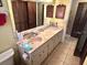 Bathroom with a long vanity featuring double sinks and tile flooring at 20100 Sw 95 St, Dunnellon, FL 34431