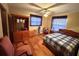 Cozy bedroom with a ceiling fan, wood floors, and a comfortable bed at 20100 Sw 95 St, Dunnellon, FL 34431