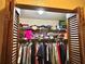 Open closet with wooden louvered doors and wire shelves at 20100 Sw 95 St, Dunnellon, FL 34431