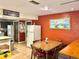 Inviting dining area features a wooden table and a painting on the rust-colored wall at 20100 Sw 95 St, Dunnellon, FL 34431