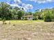 Charming single-story home with a large yard, surrounded by green trees at 20100 Sw 95 St, Dunnellon, FL 34431