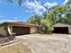 View of home featuring a two-car garage and additional covered parking at 20100 Sw 95 St, Dunnellon, FL 34431