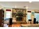 Cozy fireplace featuring stone surround, wood mantel and accents at 20100 Sw 95 St, Dunnellon, FL 34431