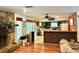 Spacious living room featuring wood floors and a stone fireplace at 20100 Sw 95 St, Dunnellon, FL 34431
