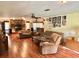 Spacious living room featuring laminate floors and cozy seating arrangements at 20100 Sw 95 St, Dunnellon, FL 34431