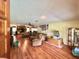 Spacious living room with wood floors, plush sofas, and many pictures on the walls at 20100 Sw 95 St, Dunnellon, FL 34431