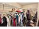 Walk-in closet with metal shelving and lots of clothes at 20100 Sw 95 St, Dunnellon, FL 34431
