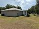 Backyard view of the house featuring a screen porch and fenced yard at 27 Cedar Tree Ter, Ocala, FL 34472