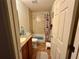 Cozy bathroom featuring tiled shower over tub with colorful shower curtain and vanity sink at 27 Cedar Tree Ter, Ocala, FL 34472